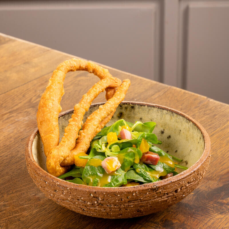 Spinach Salad with Orange and lalagia (fried dough strips)